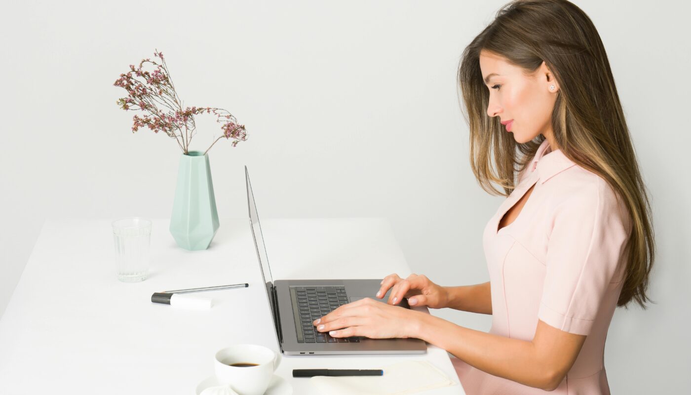 image source: https://www.pexels.com/photo/woman-in-pink-dress-using-laptop-computer-1586973/