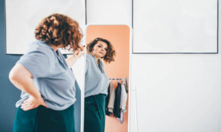 https://media.gettyimages.com/id/1369562988/photo/overweight-young-woman-in-glasses-admires-choice-of-clothes-standing-in-front-of-large-mirror.jpg?s=612x612&w=0&k=20&c=70-pyt87U8fWqhiiz0VH40q1Y5k1GtQfiA46PaNaY0A=