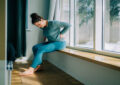 https://media.gettyimages.com/id/2205828864/photo/woman-suffering-from-back-pain-while-sitting-near-window-at-home.jpg?s=612x612&w=0&k=20&c=urs7AxfbZjdQLScPrUsfmSdHMLYYphP4LmxNpJ74JIM=
