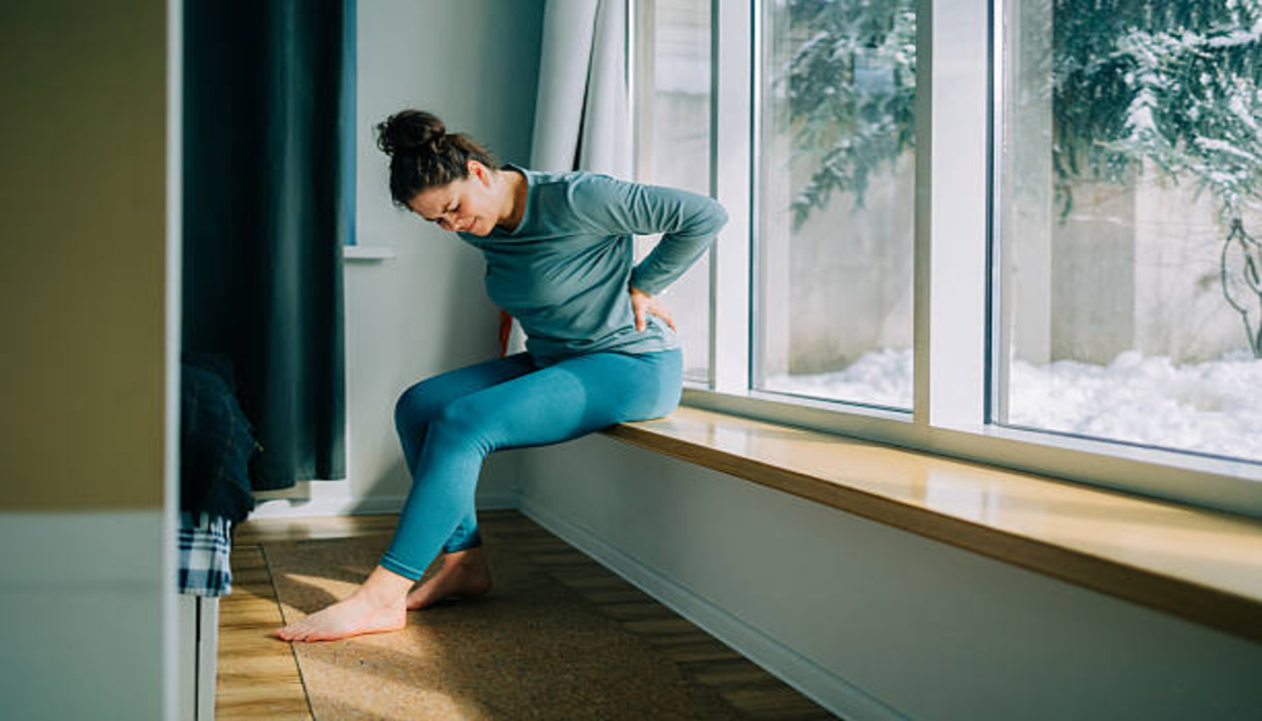 https://media.gettyimages.com/id/2205828864/photo/woman-suffering-from-back-pain-while-sitting-near-window-at-home.jpg?s=612x612&w=0&k=20&c=urs7AxfbZjdQLScPrUsfmSdHMLYYphP4LmxNpJ74JIM=