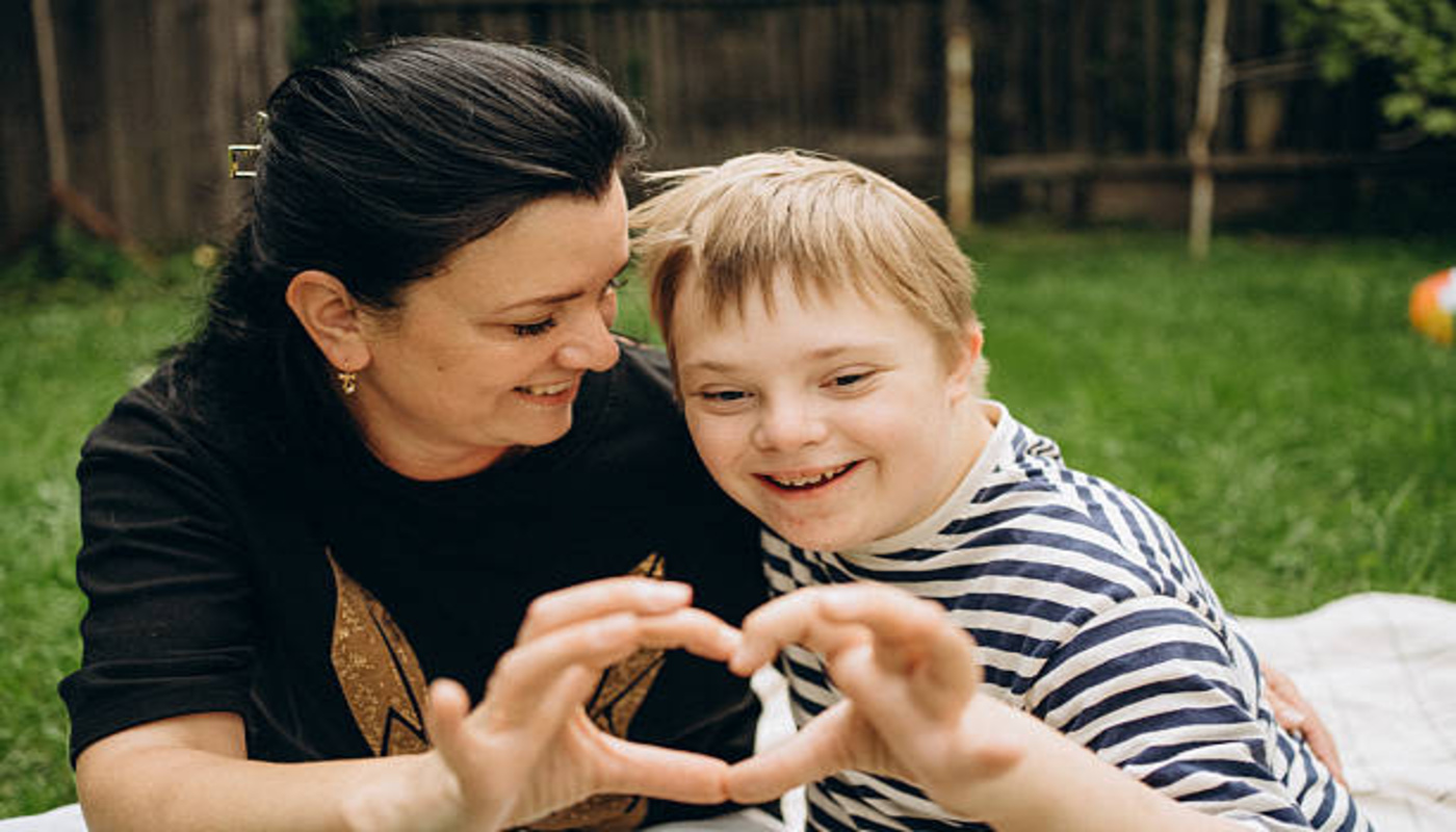 https://media.gettyimages.com/id/2230443095/photo/mother-and-son-with-down-syndrome-making-heart-shape-with-hands.jpg?s=612x612&w=0&k=20&c=BxxnFxGbbdUqpDfuWCipvkWx99EdZdAnYTjV6rH2Vkc=