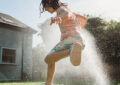 https://media.gettyimages.com/id/2224676887/photo/a-carefree-little-girl-enjoys-a-moment-of-refreshment-running-through-a-sprinkler-in-a-garden.jpg?s=612x612&w=0&k=20&c=C3NjsB02V9IpwyYhP9XRk8gc1vgHztZRGe3X5Pzf-ys=