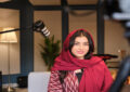 https://media.gettyimages.com/id/2201103120/photo/smiling-saudi-woman-sitting-next-to-microphone.jpg?s=612x612&w=0&k=20&c=KRJIuwd6Yii7m5aCAEQ02byc0ePH-GYklHrykcEs7Aw=
