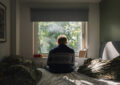 https://media.gettyimages.com/id/2236067002/photo/rear-view-of-a-depressed-man-looking-out-of-his-bedroom-window-on-a-sunny-day-negative-emotion.jpg?s=612x612&w=0&k=20&c=Mkq-3Mv_-nW6s1HJNbKlhWZMk8tVzxQOS-TKXOAyyNA=