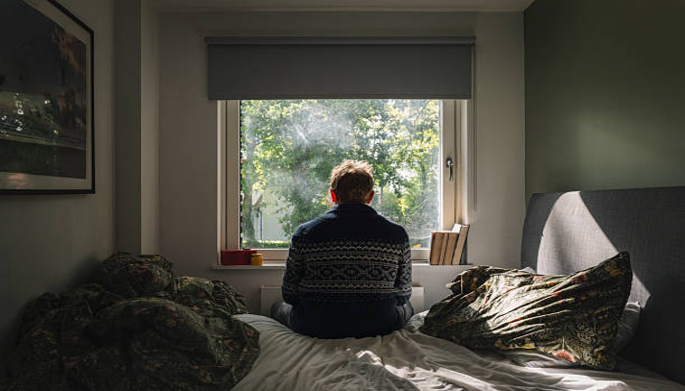 https://media.gettyimages.com/id/2236067002/photo/rear-view-of-a-depressed-man-looking-out-of-his-bedroom-window-on-a-sunny-day-negative-emotion.jpg?s=612x612&w=0&k=20&c=Mkq-3Mv_-nW6s1HJNbKlhWZMk8tVzxQOS-TKXOAyyNA=